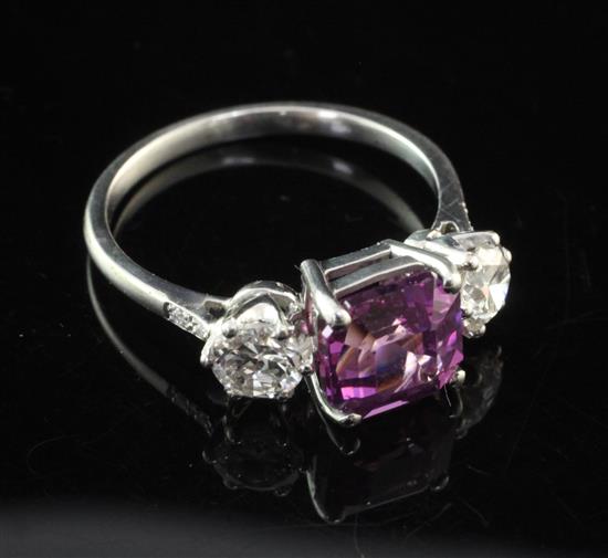 A white gold and three stone purple sapphire and diamond ring, size M.